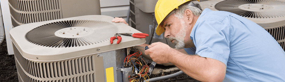 HVAC Repairman working on AC Unit